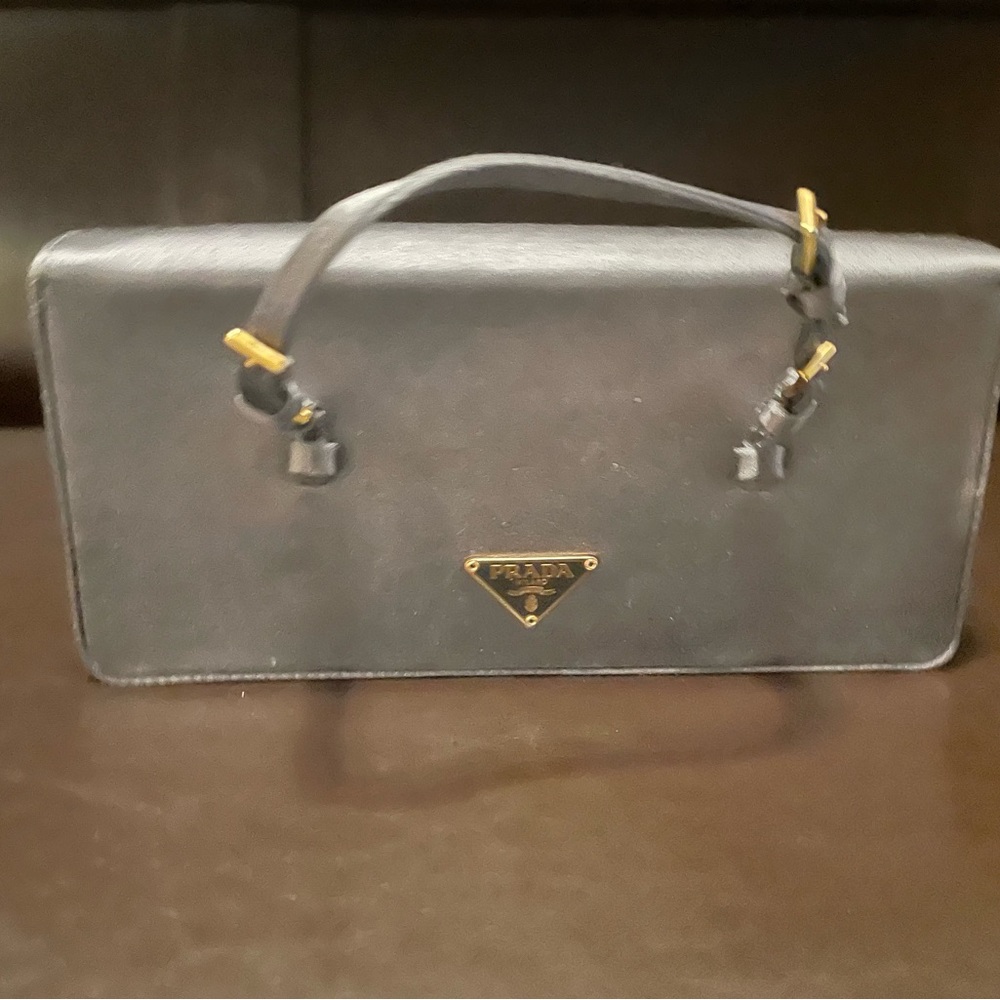 Authentic! Prada gray satin mini bag with top handle.